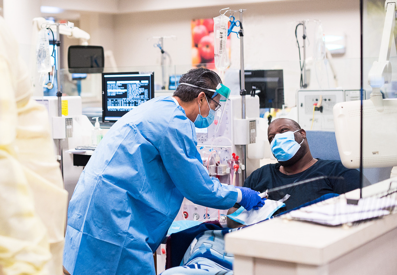 healthcare worker in scrubs and patient