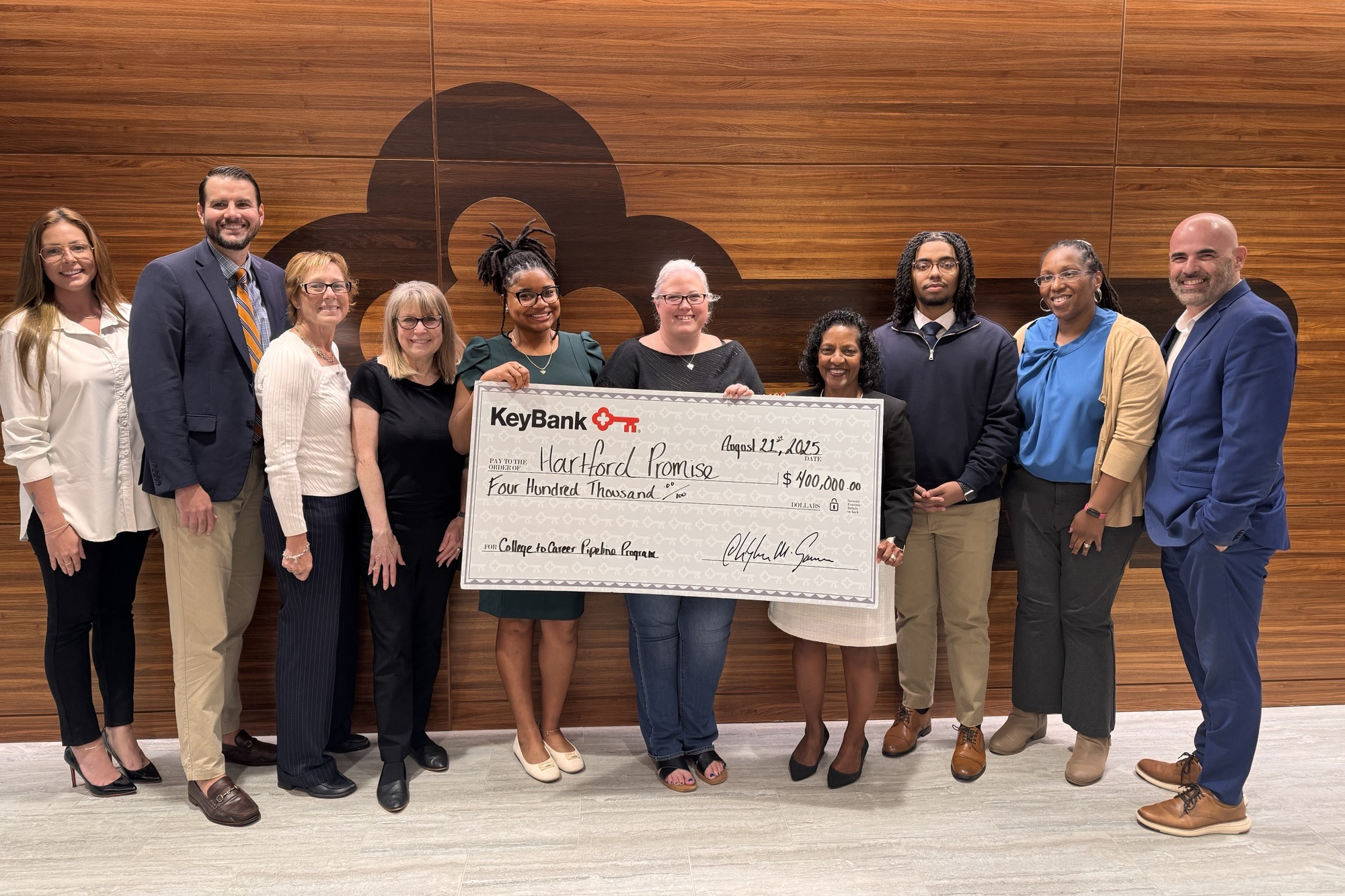 Small group holding an oversized check for Hartford Promise