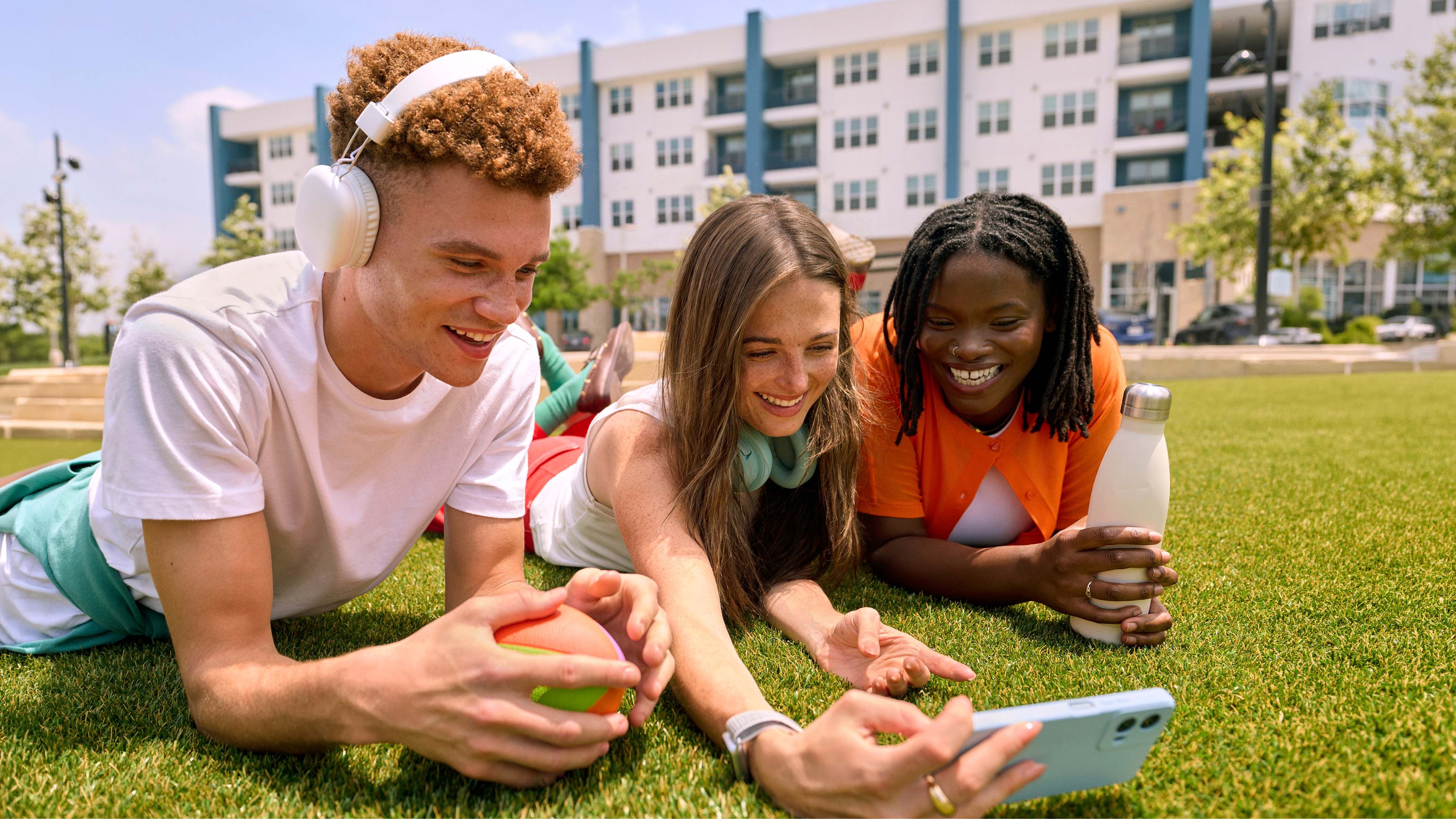 people lying in the grass together