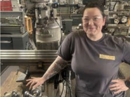 Woman in front of machinery