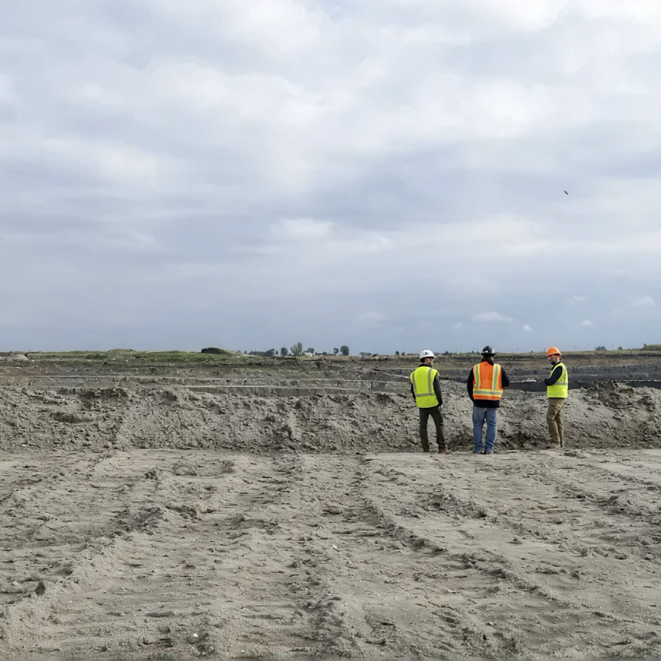 Workers looking out over former mining site