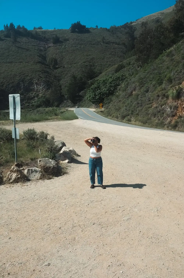 Jalyn taking a photo at the seashore.