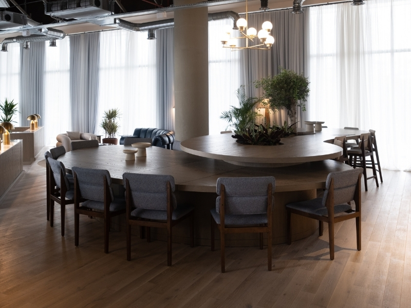 An ergonomic conference table with chairs and a chandelier