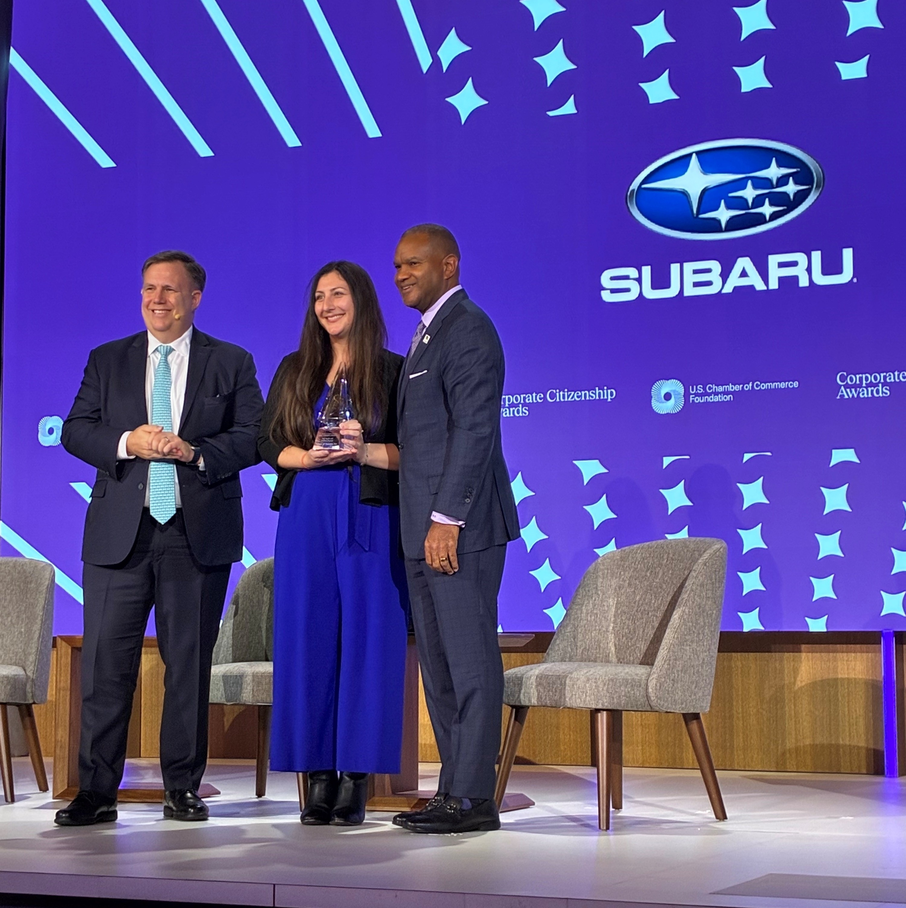 people holding an award together