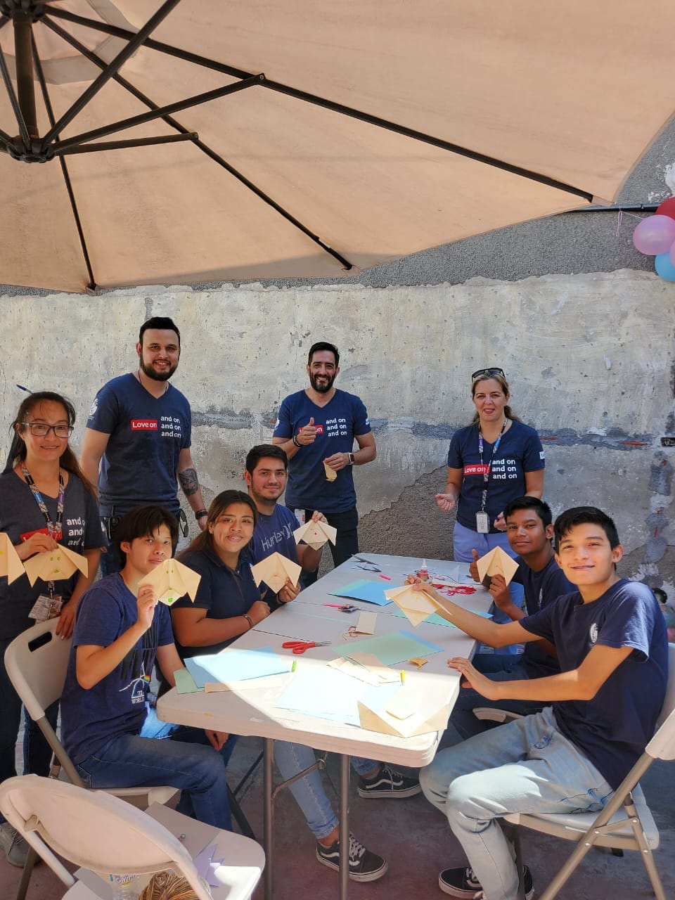 Group doing paper crafts at outside table