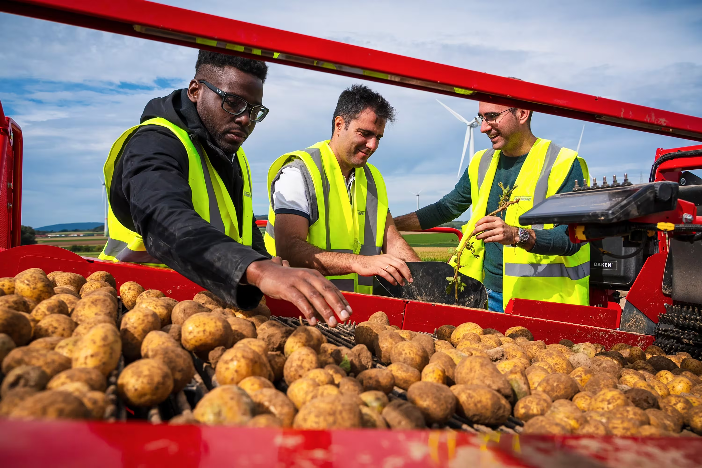 3 people harvesting potatoes