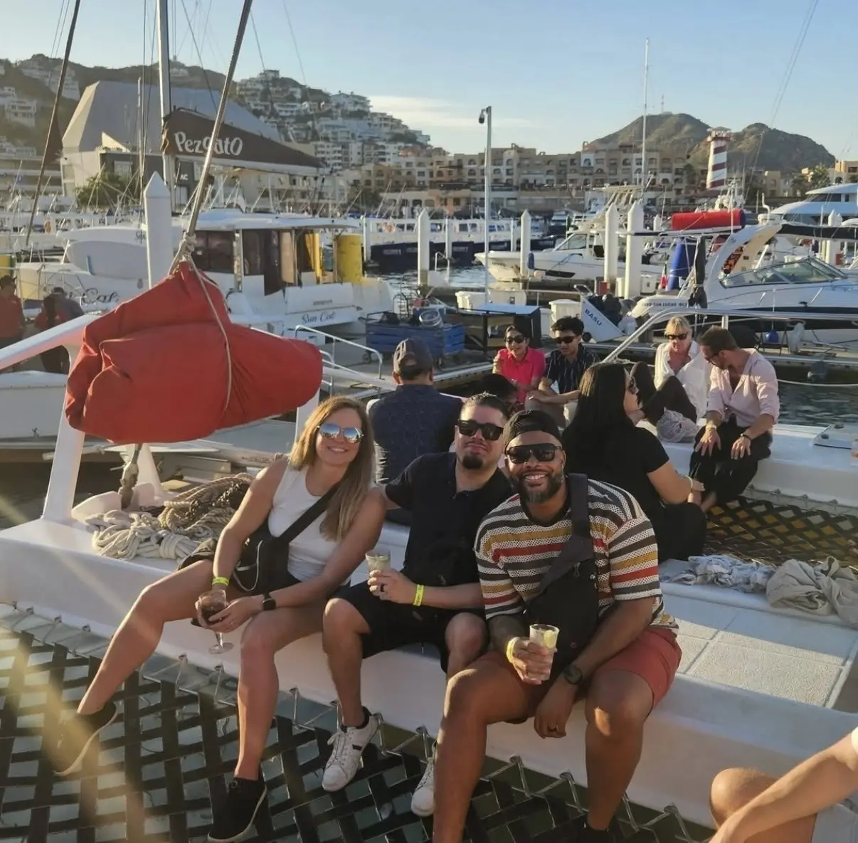 Alex Hernandez and other sitting on the side of a boat