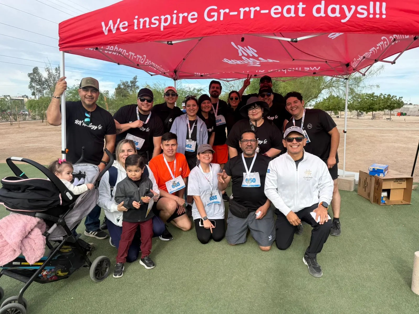 Mexicali team handing out food and cheering on participants at a local race.