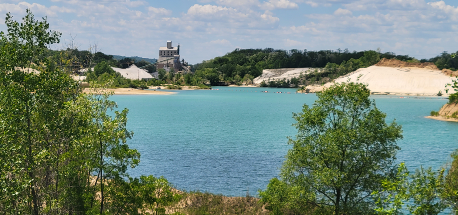 Body of water and white sandy cliff at Covia's Portage plant