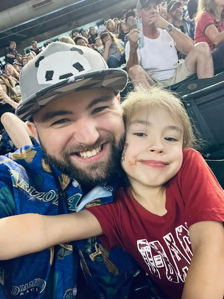 Shawn and his son at a baseball game.