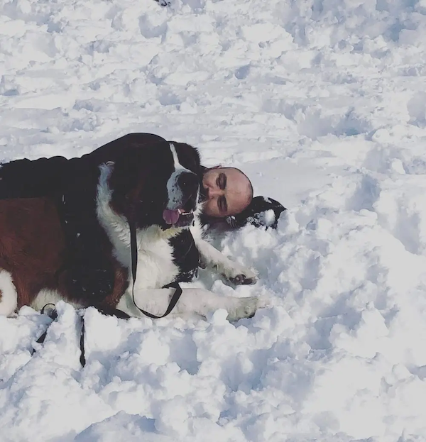 Shawn with his dog in the snow.