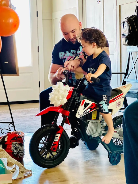 Shawn and his son with his new bike.