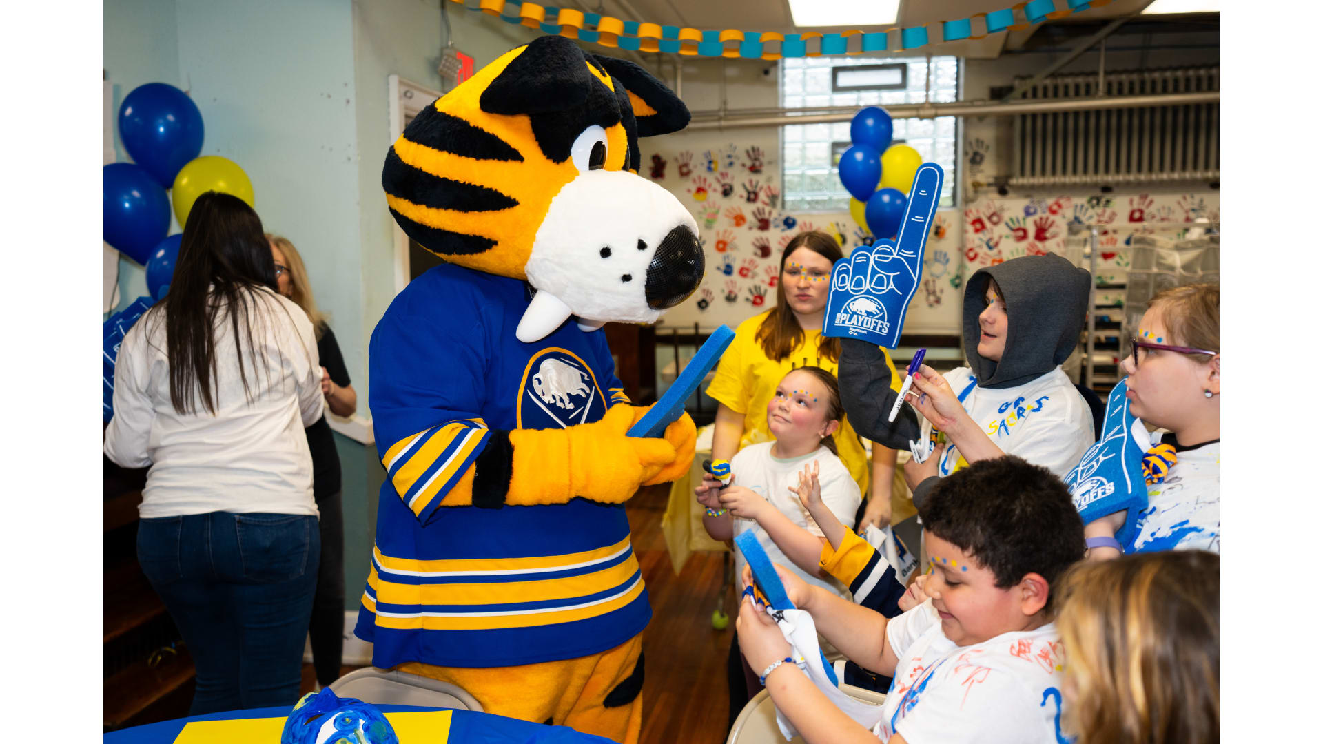 Sabres mascot with children