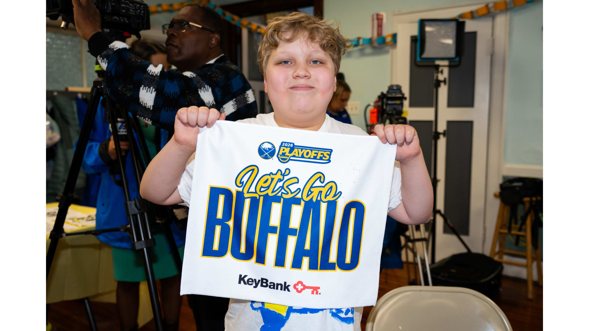 Child holding up a t-shirt