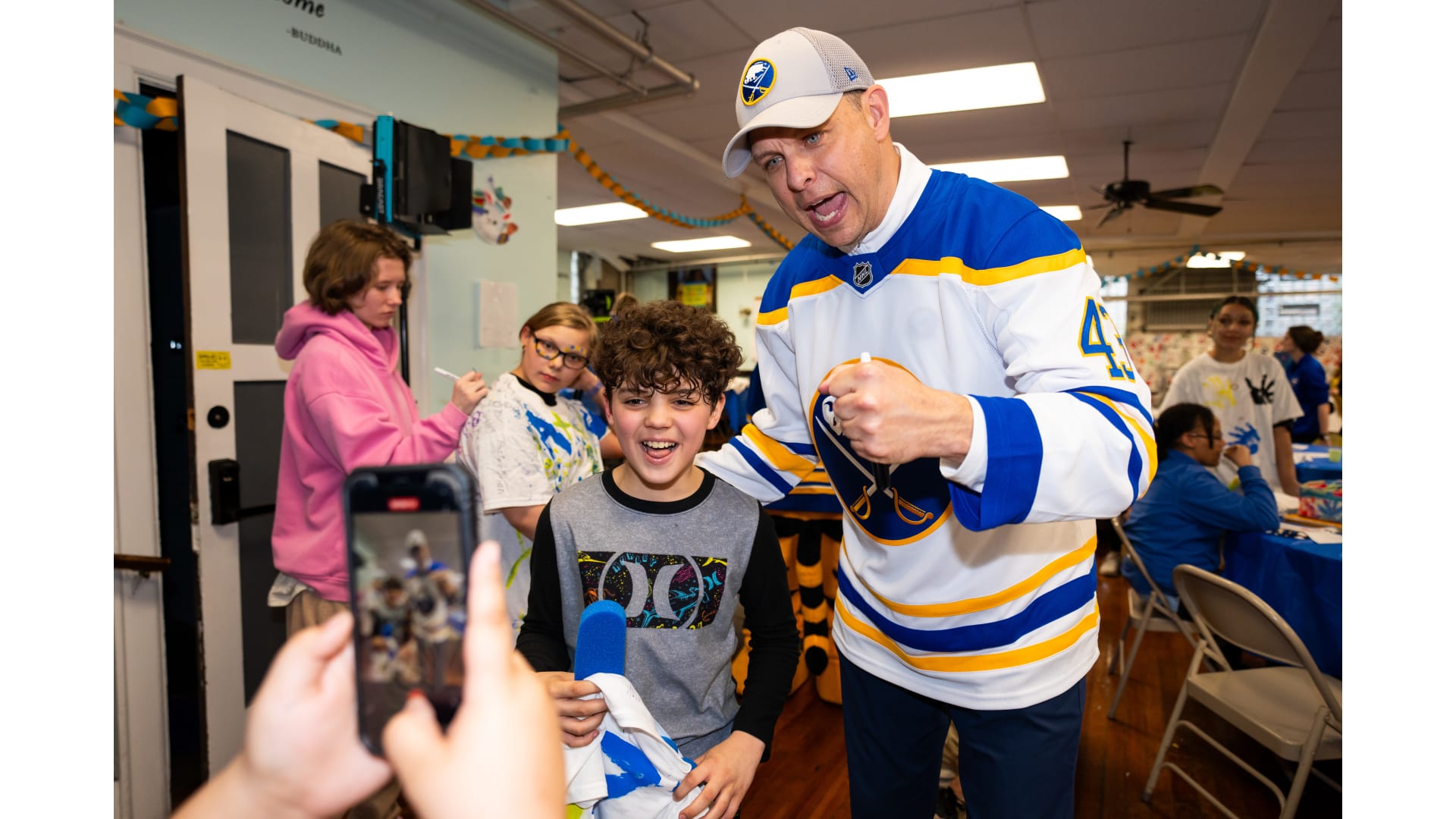 A player posing with a child for a selfie