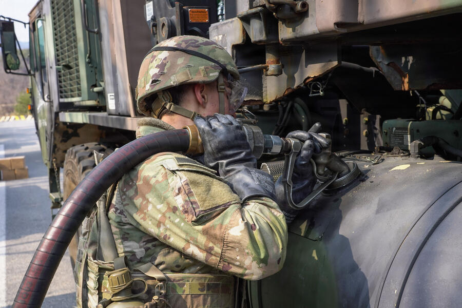 person fueling up a tank