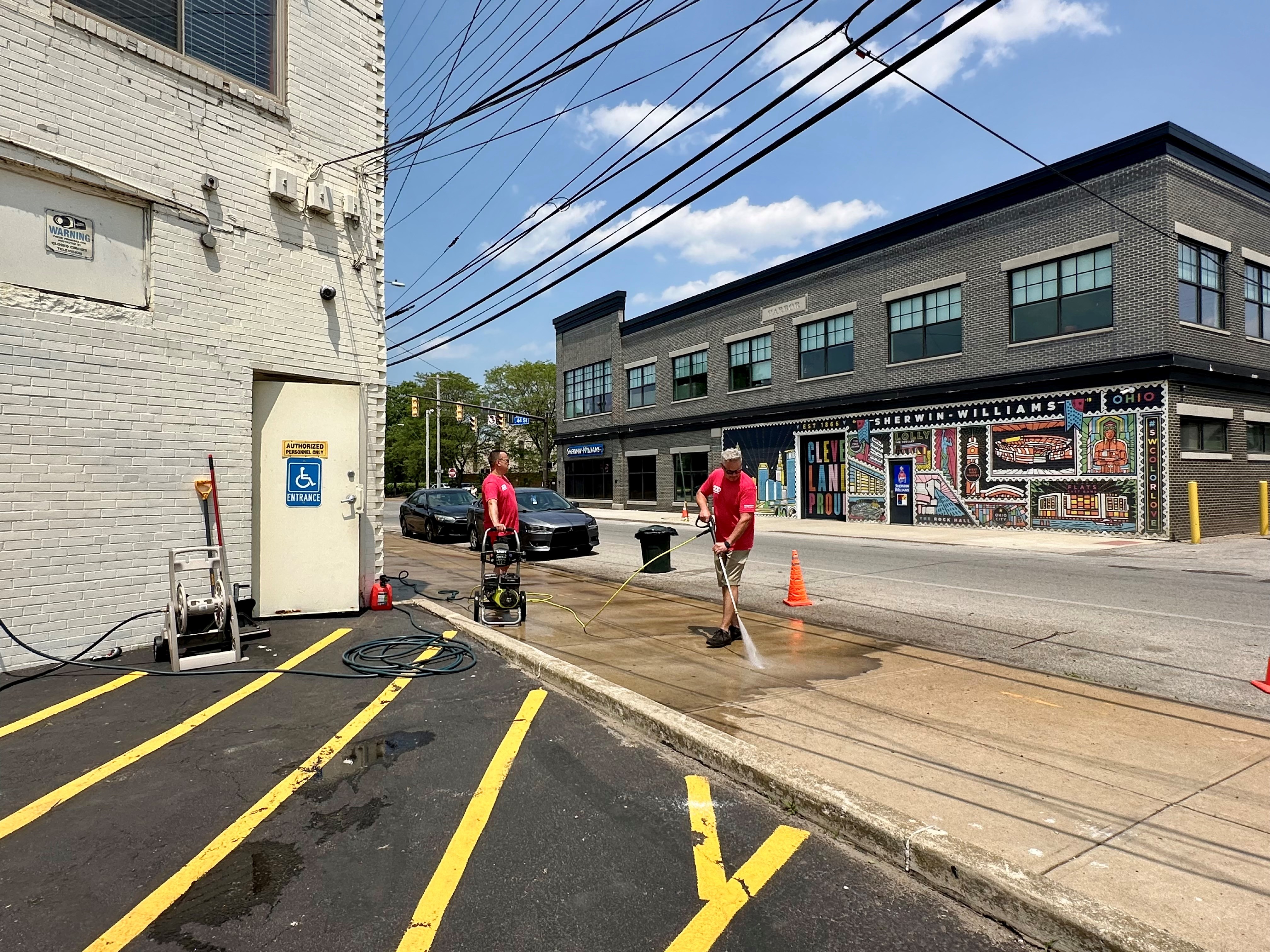 people cleaning the sidewalk