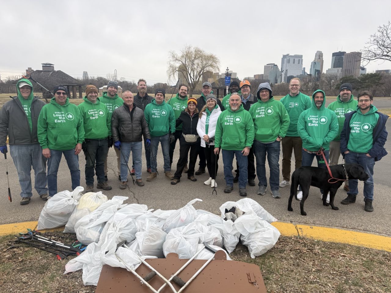 Group of volunteers behind full garbage bags