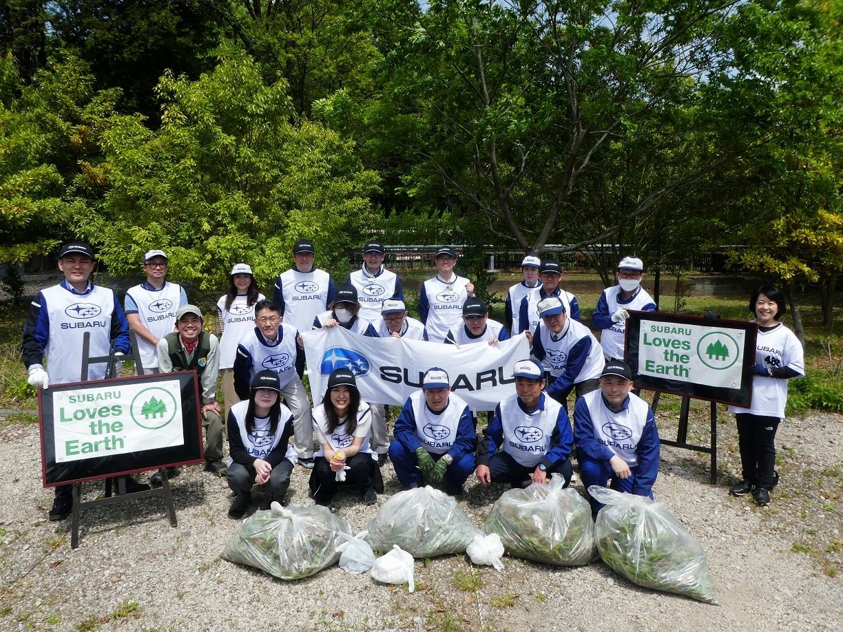Volunteers pose with full garbage bags