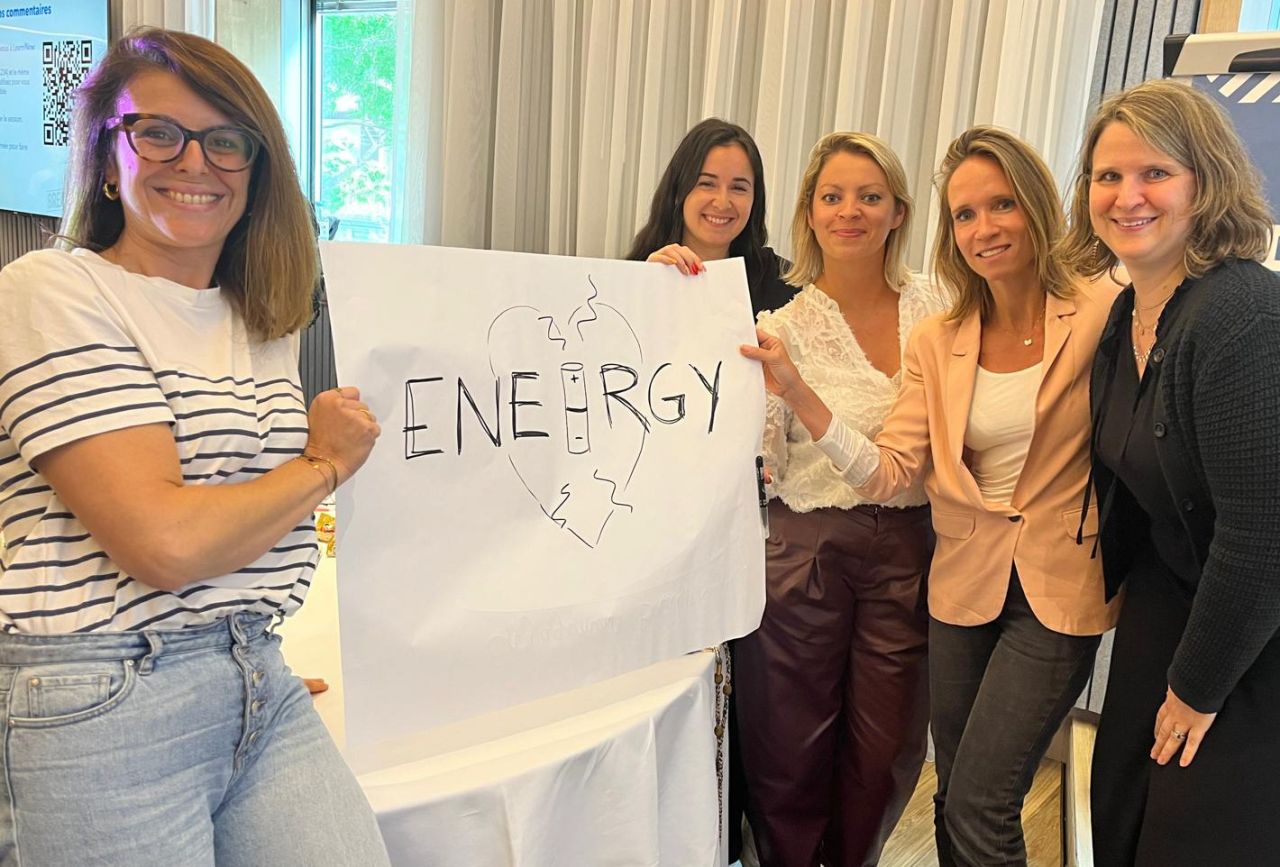 Five people holding up a sign that reads "Energy"