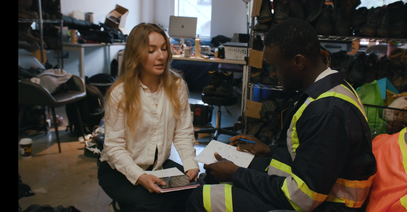 Working Gear Intern speaks with a participant in the program