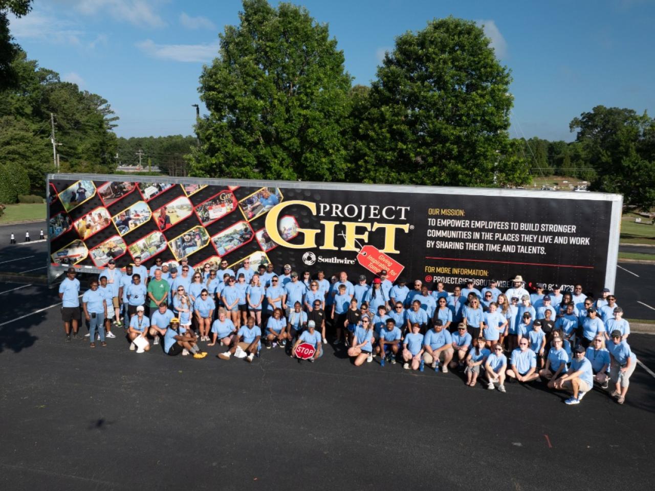 Group photo of Southwire volunteers in front of Project GIFT trailer