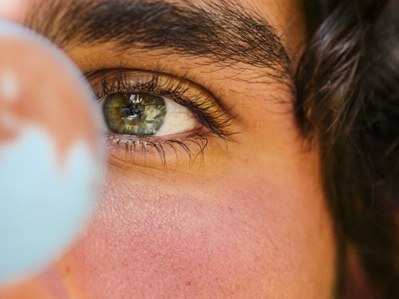 person looking at a globe