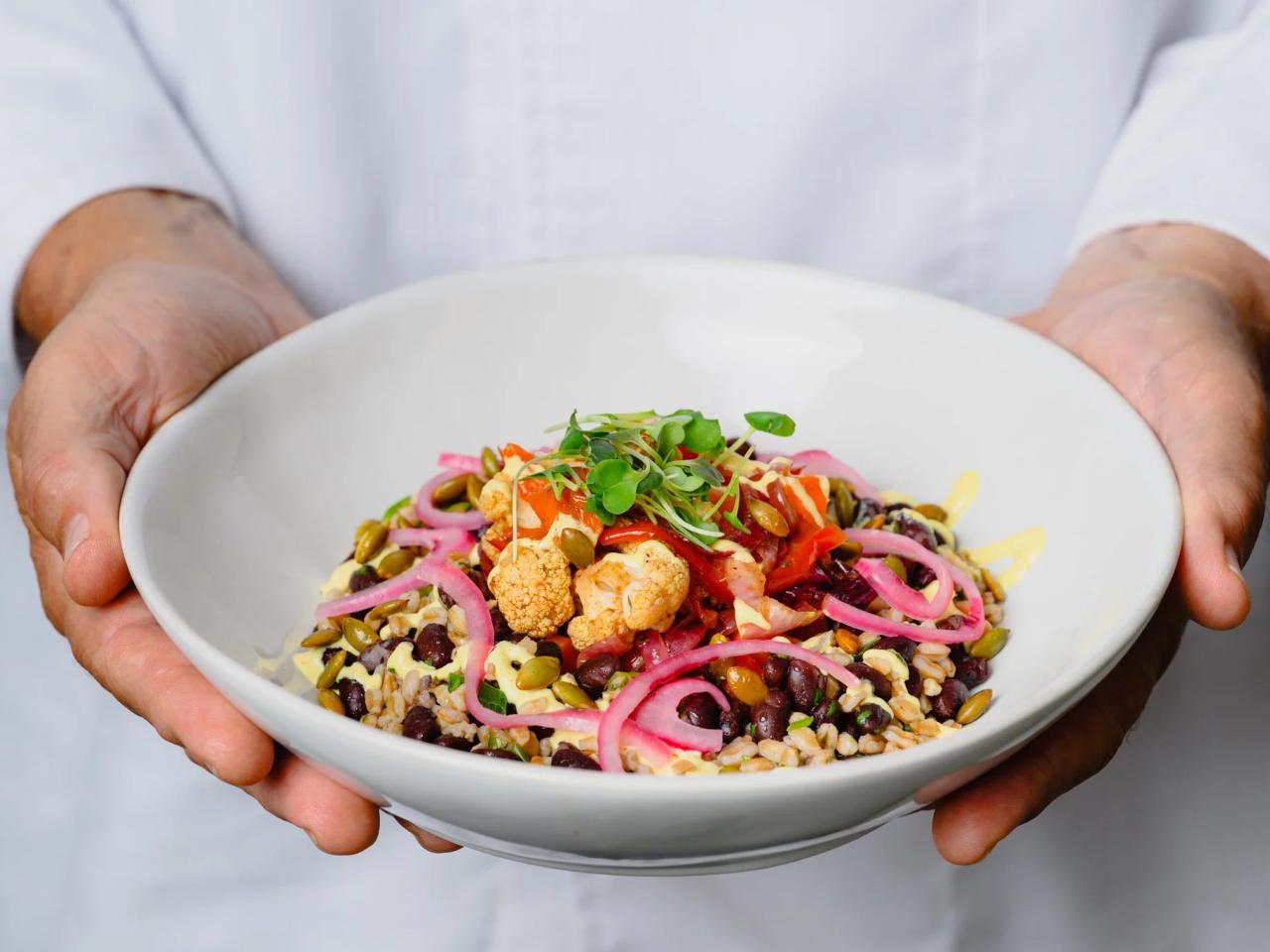 person holding out a dish of food
