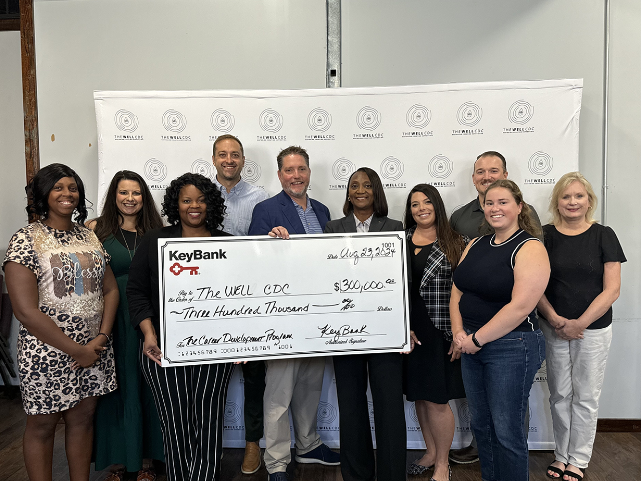 A group of people posing with an oversized check