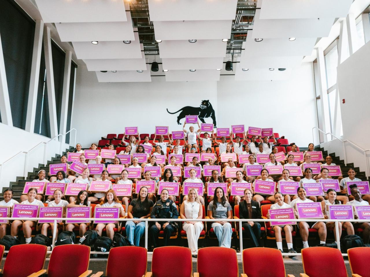 Group photo of camp participants holding boxes from Lenovo