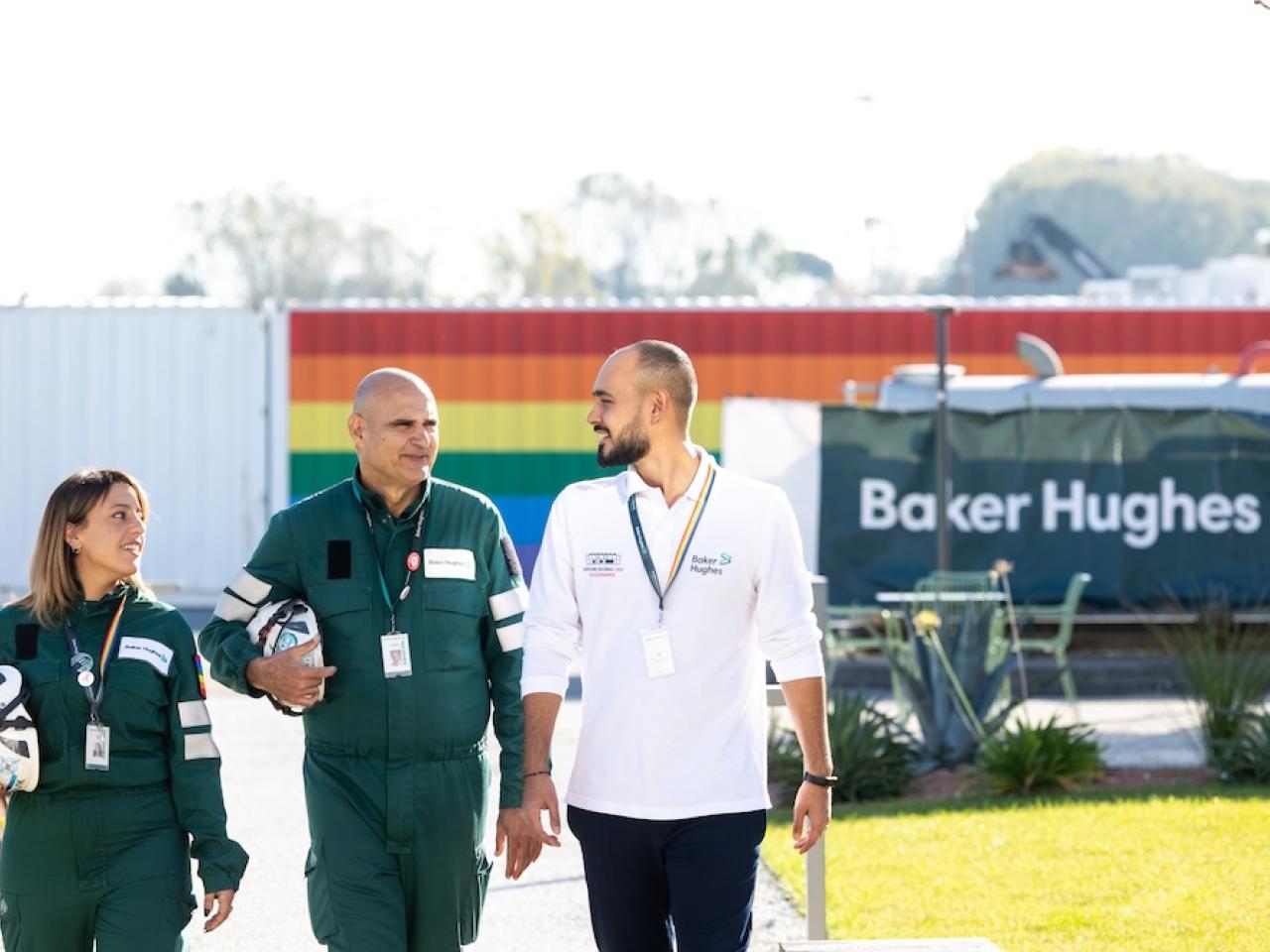 Three employees walking together outside