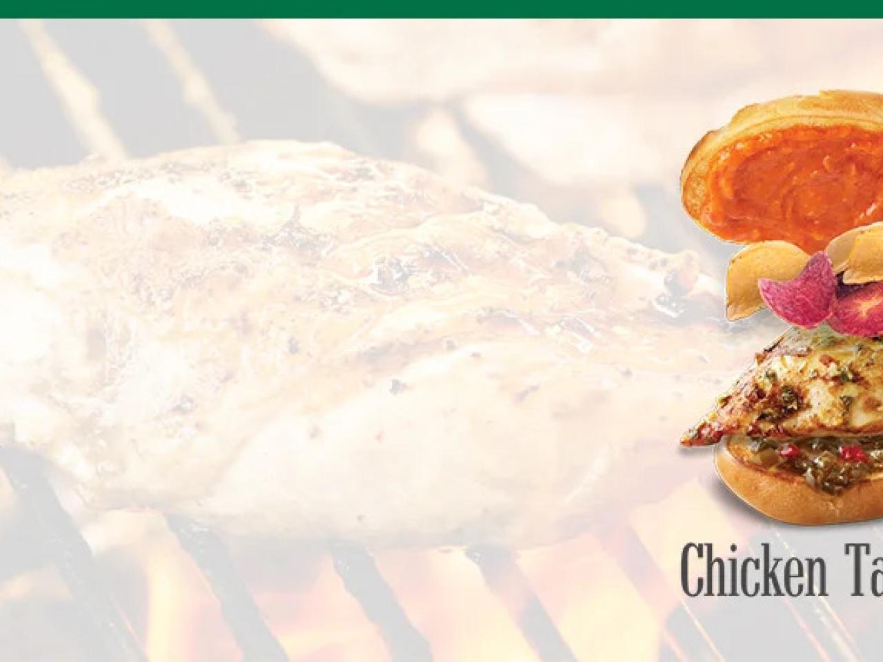 On a faded background of chicken on a flame grill, a chicken sandwich and "Chicken takes flight"