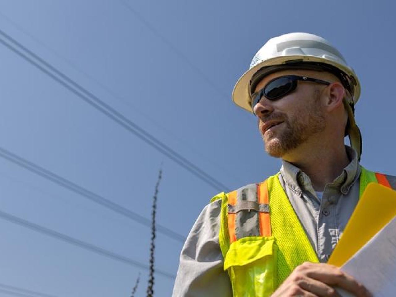 Will Ricks wearing a safety hat and hi-viz