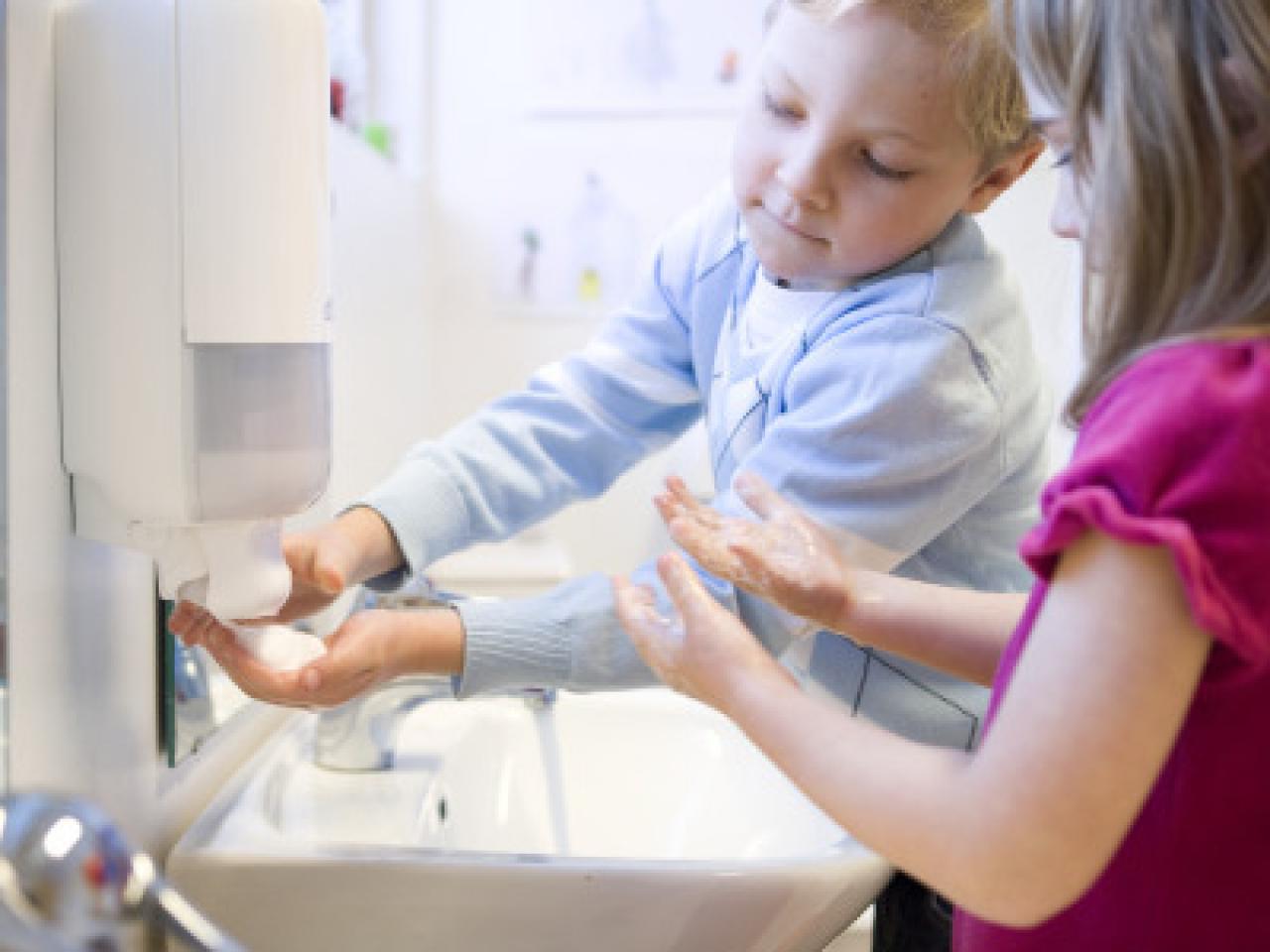 Children washing their hands.