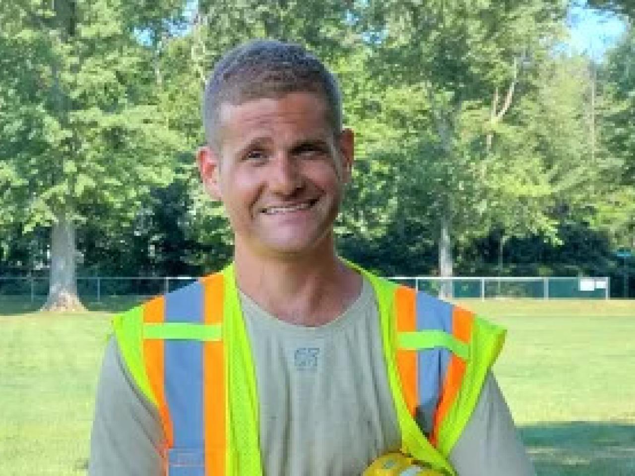 Jonathan Harmon, wearing a safety vest outside