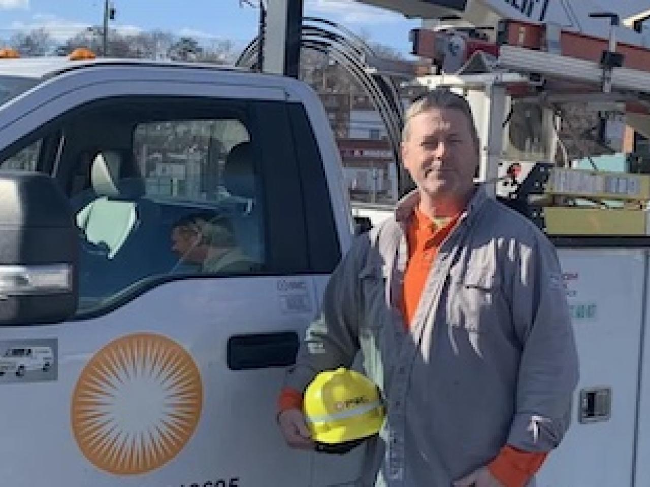 Photo of Don Brett standing in front of his PSEG truck.