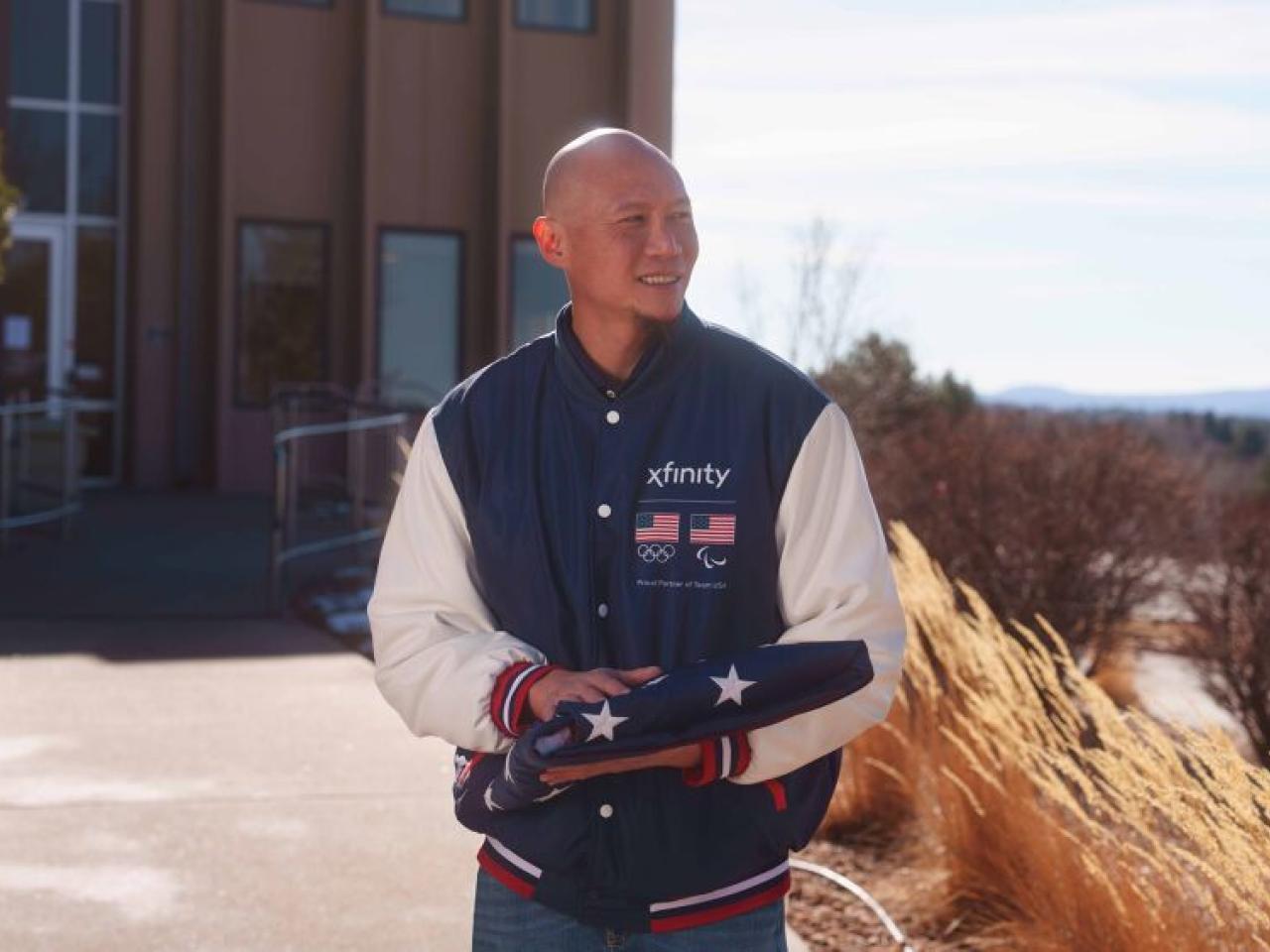 U.S. Paralympic Gold Medalist Jen Lee holding folded up American flag
