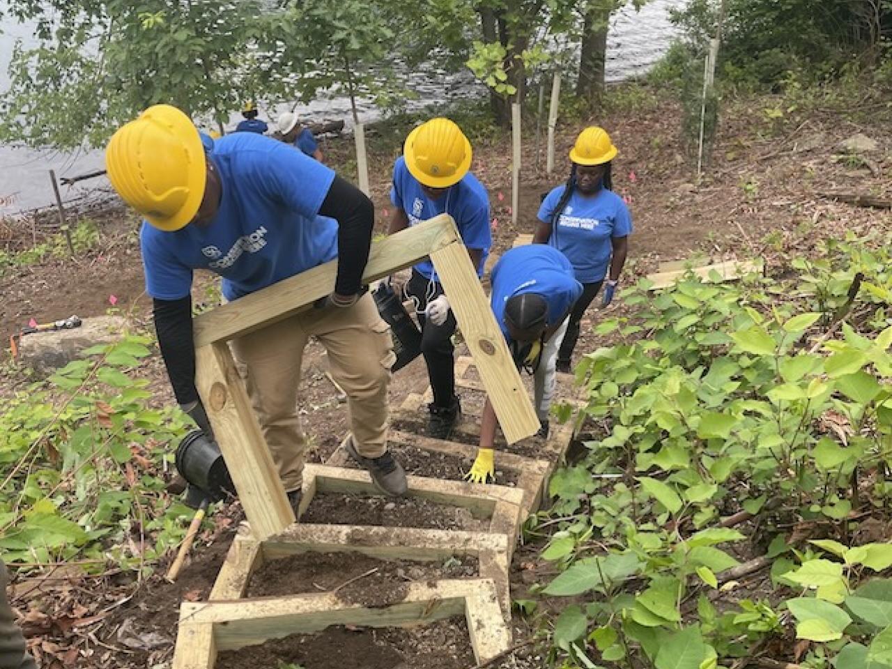 SCA Team members working on steps in a park.