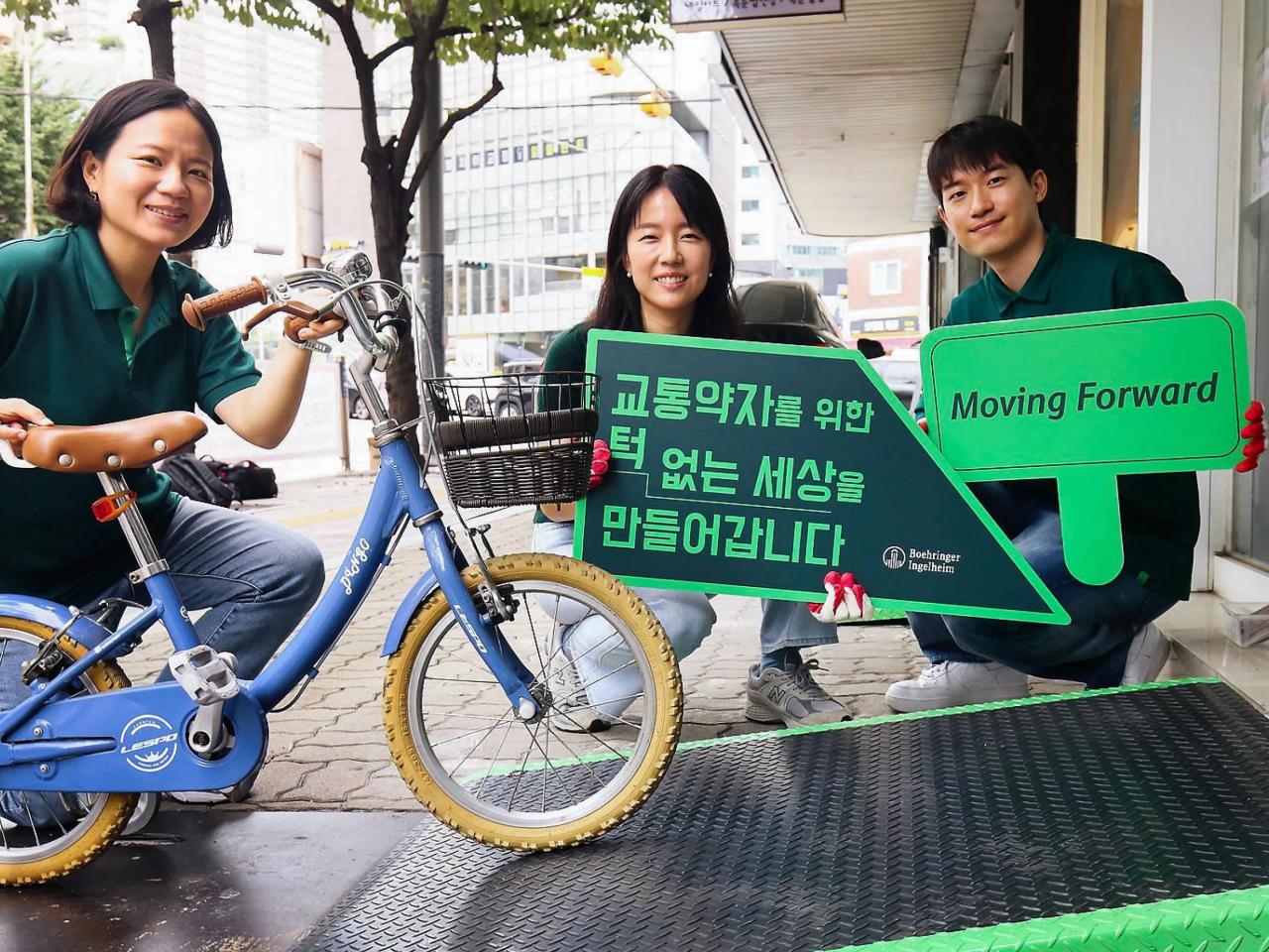 people holding up signs and a small bike