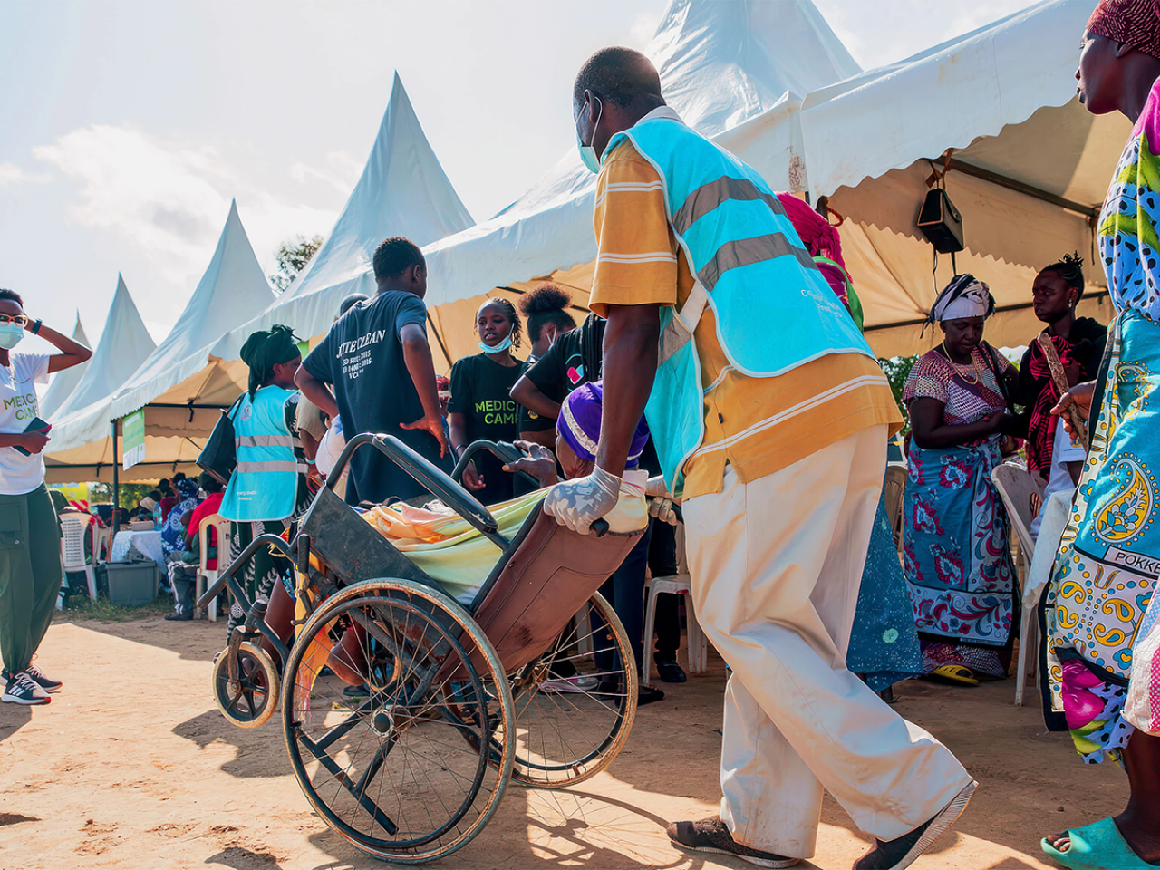 healthcare worker wheeling a patient