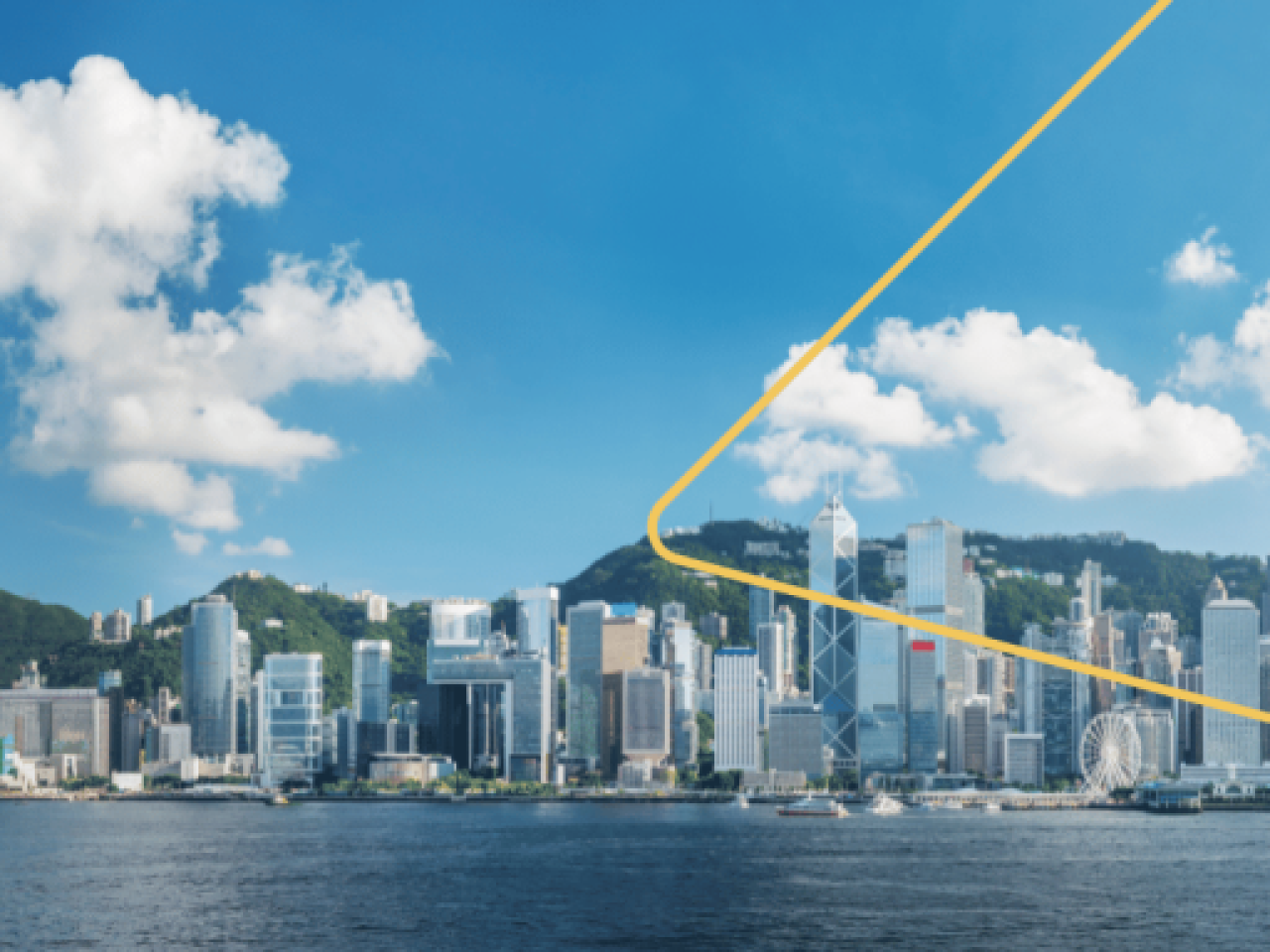 City skyline with an expanse of water in front. A few clouds in a blue sky above.