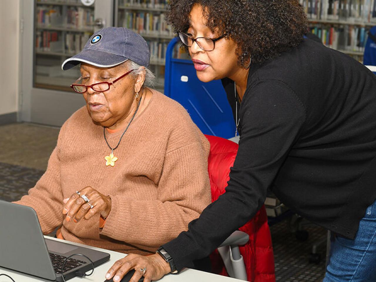 One person teaching another computer skills