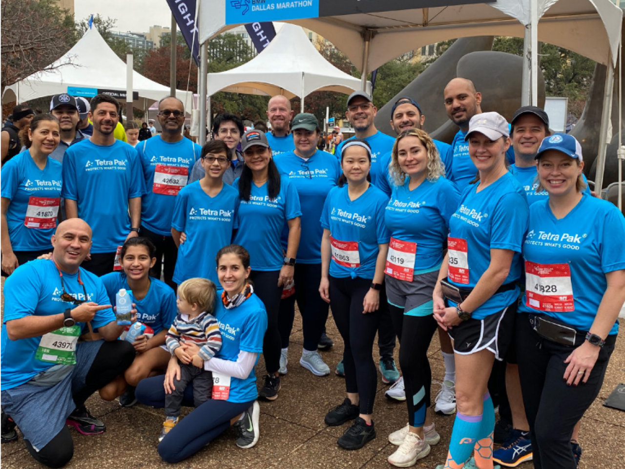 A posed group of runners and fans.
