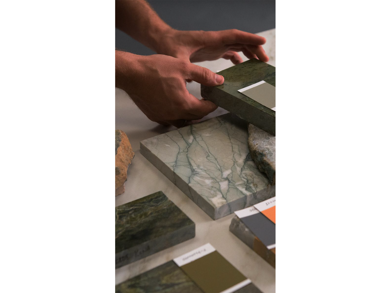 comparing paint swatches with marble material