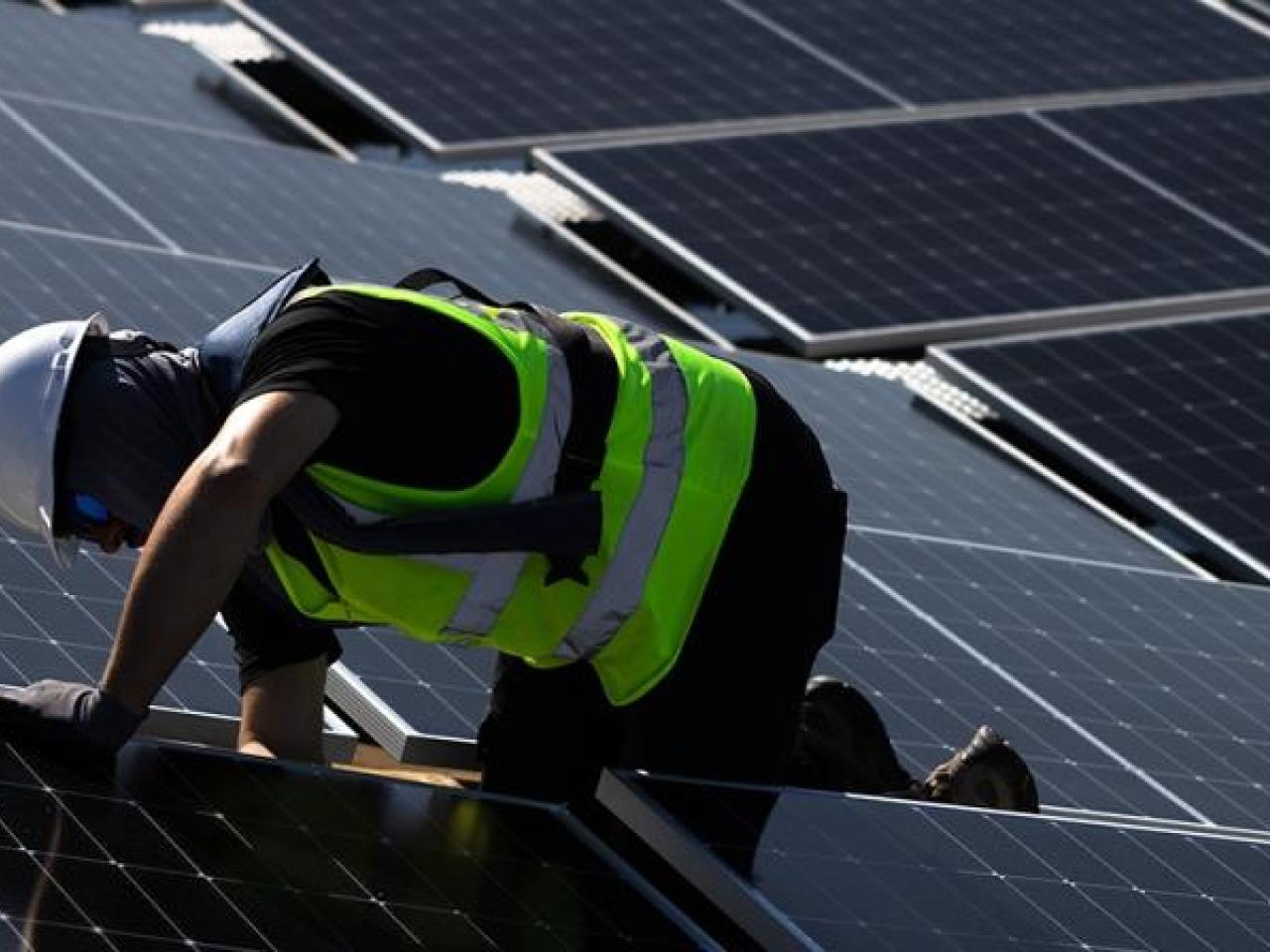 Worker installing polar panels  