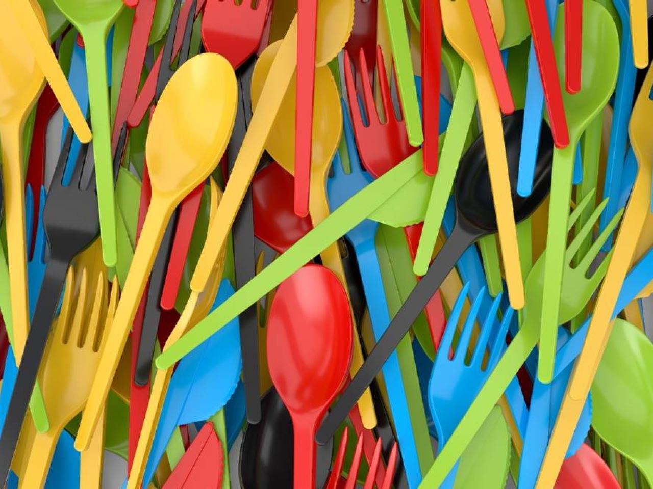 Close up of a pile of colorful plastic cutlery