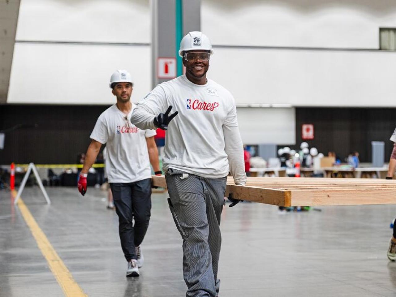 volunteers carrying things and smiling