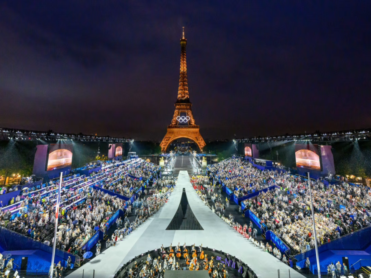 a large crowd in front of the Eiffel Tower