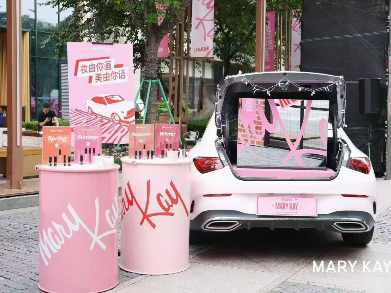 cosmetics display next to a car