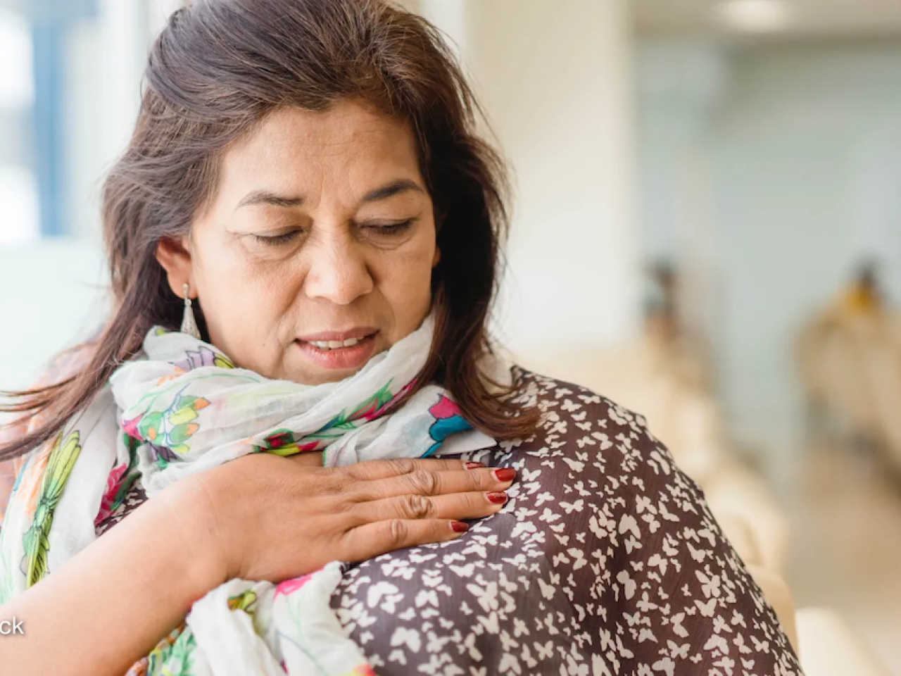 A woman stands in a clinic at a cancer checkup in India. Photo by: Adobe Stock